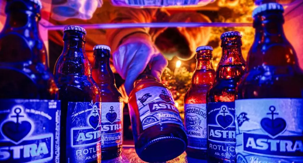 a group of beer bottles in a refrigerator