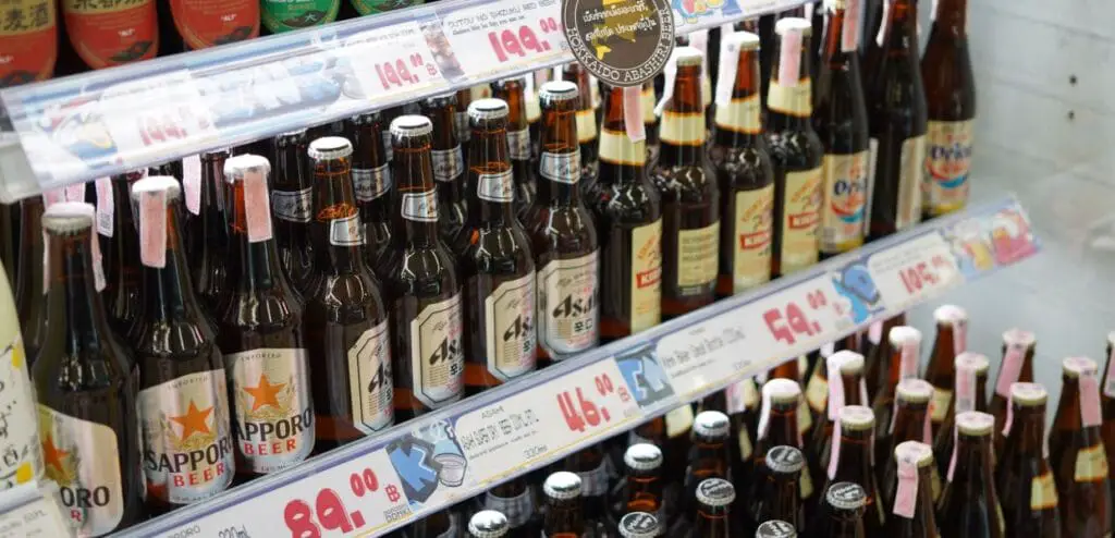 a shelf with bottles of beer